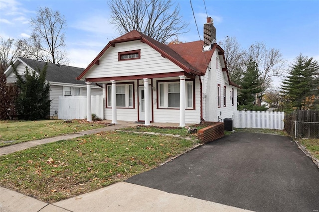 bungalow-style home with a porch and a front lawn