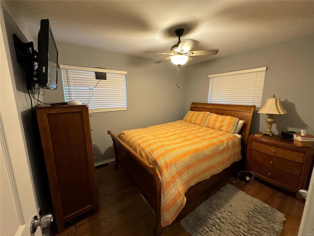 bedroom with ceiling fan and dark wood-type flooring