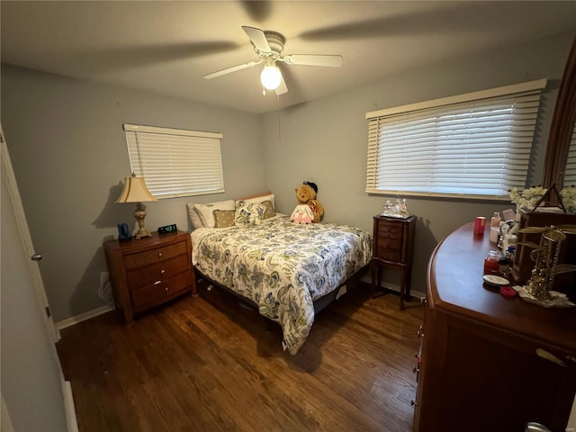 bedroom with dark hardwood / wood-style floors and ceiling fan