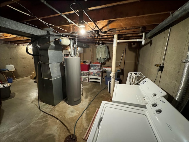 basement featuring heating unit, water heater, and washer and clothes dryer