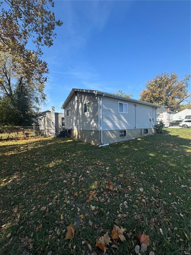 back of property with a lawn