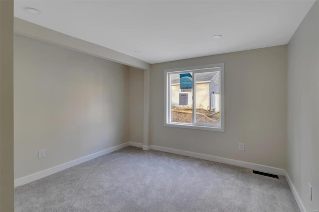 empty room featuring light colored carpet