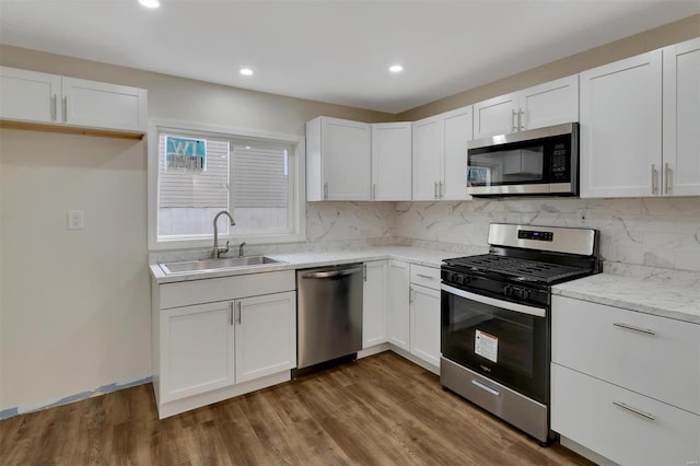 kitchen with white cabinetry, sink, appliances with stainless steel finishes, and dark wood-type flooring