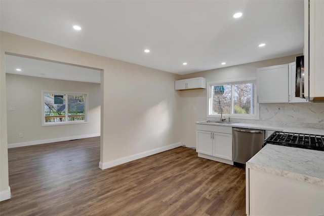 kitchen with plenty of natural light, dark hardwood / wood-style flooring, white cabinetry, and appliances with stainless steel finishes