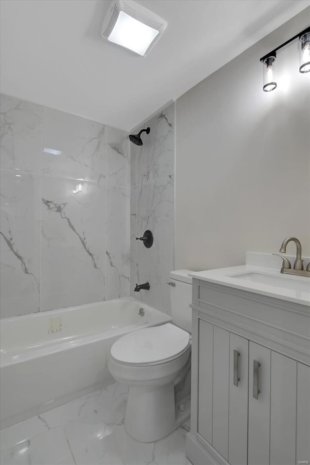 full bathroom featuring vanity, tiled shower / bath combo, and toilet