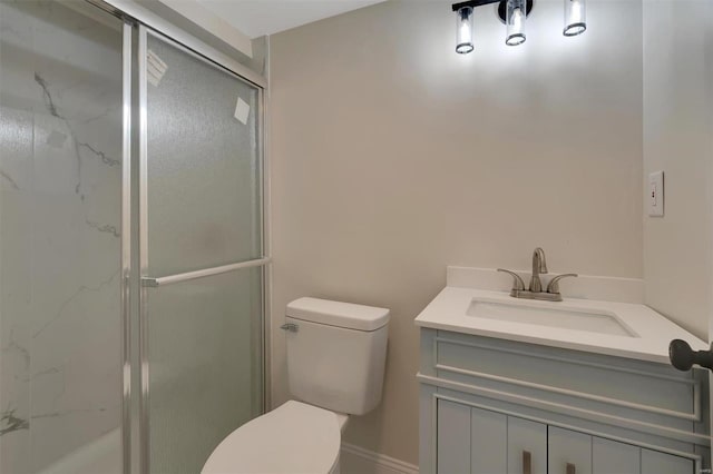 bathroom featuring vanity, toilet, and an enclosed shower