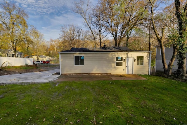 back of property with a patio and a lawn