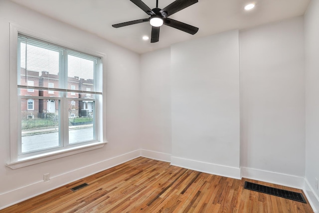 empty room with wood-type flooring and ceiling fan