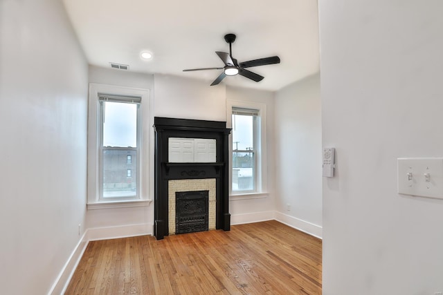 unfurnished living room featuring ceiling fan and light wood-type flooring