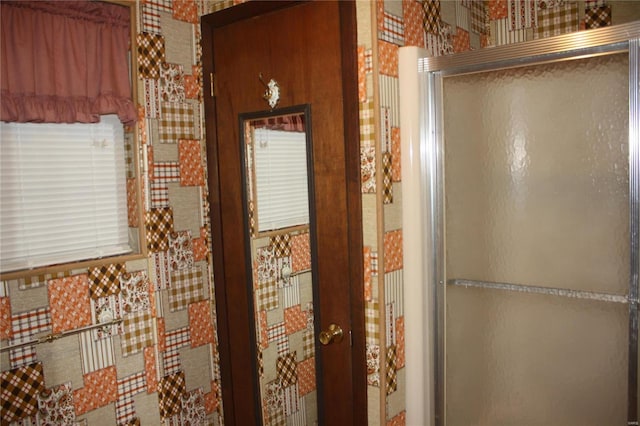 bathroom with a shower with door