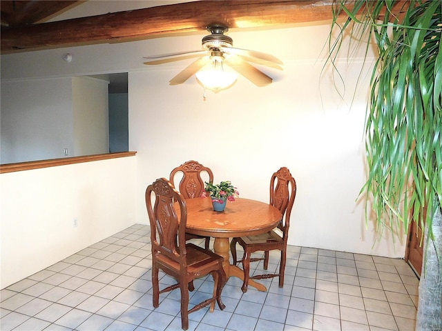 tiled dining area featuring beam ceiling and ceiling fan