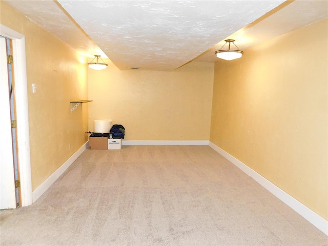 basement with carpet flooring and a textured ceiling