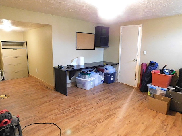 interior space featuring a textured ceiling and light hardwood / wood-style flooring