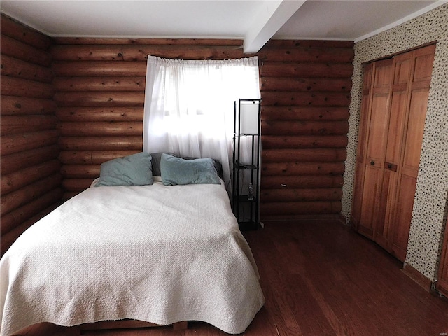 bedroom featuring rustic walls, a closet, and dark wood-type flooring