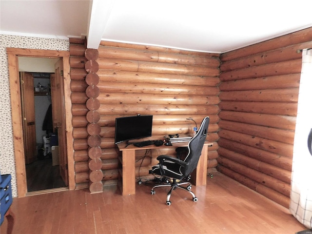 unfurnished office with log walls and hardwood / wood-style flooring