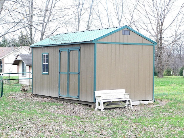 view of outbuilding featuring a lawn