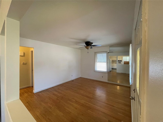 spare room with ceiling fan and wood-type flooring