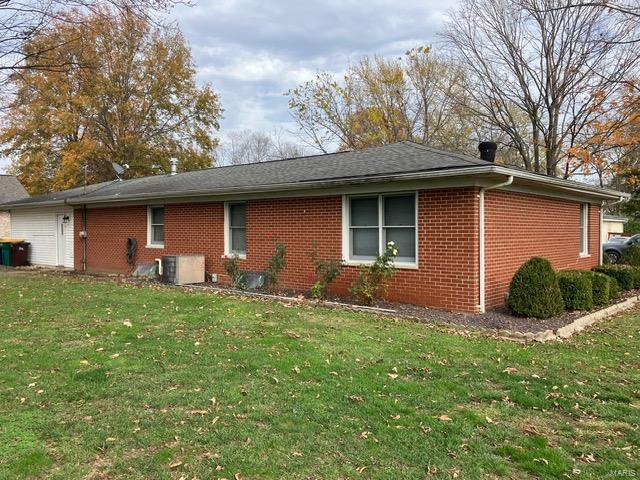 view of side of home featuring a yard