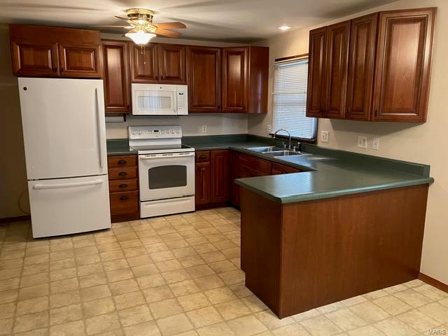 kitchen with white appliances, ceiling fan, and sink