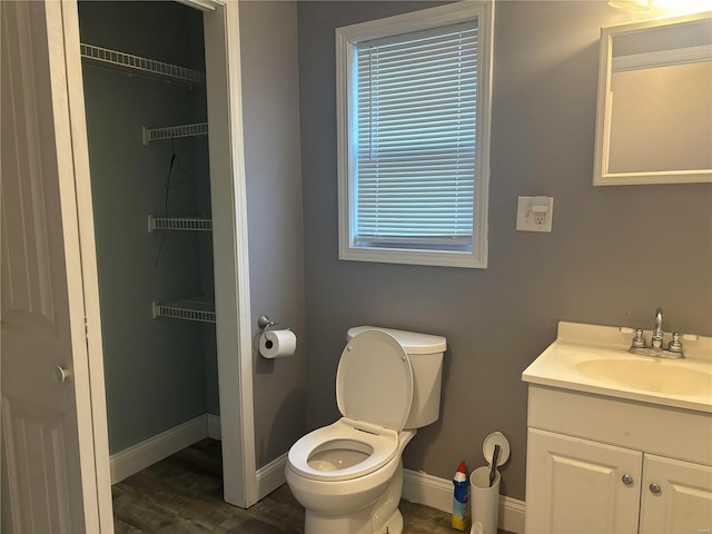 bathroom featuring hardwood / wood-style floors, vanity, and toilet