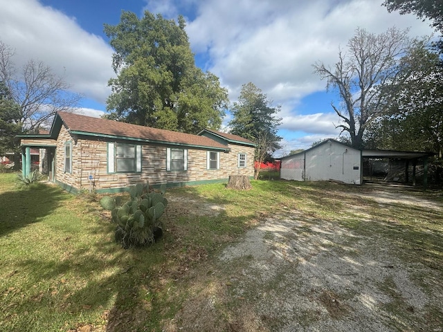 view of side of property featuring a yard and a carport