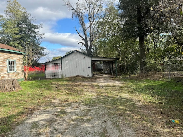 view of yard with an outdoor structure and a carport