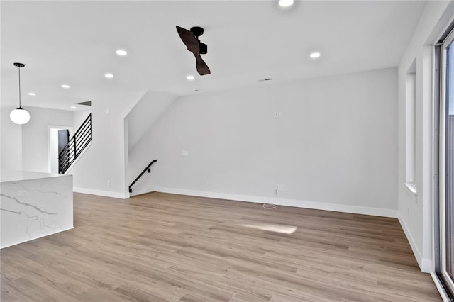 unfurnished living room with ceiling fan and light wood-type flooring