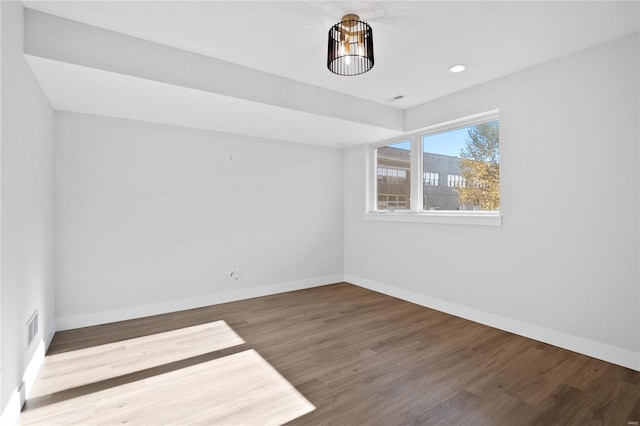 spare room featuring wood-type flooring