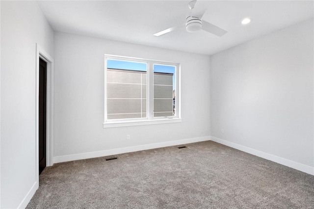 carpeted empty room featuring ceiling fan