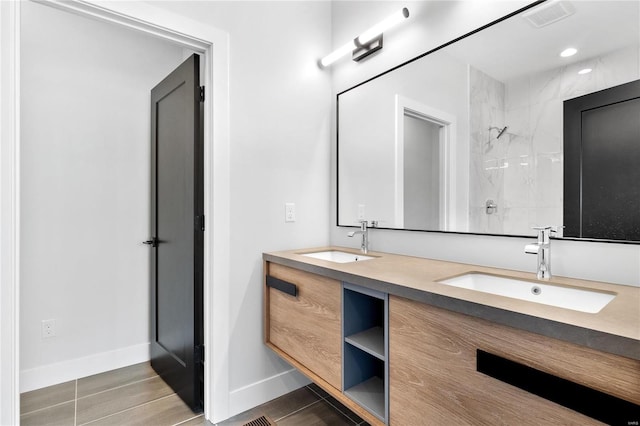 bathroom with tiled shower, vanity, and hardwood / wood-style flooring