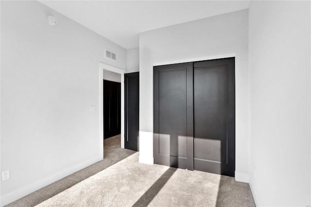 carpeted bedroom featuring a closet