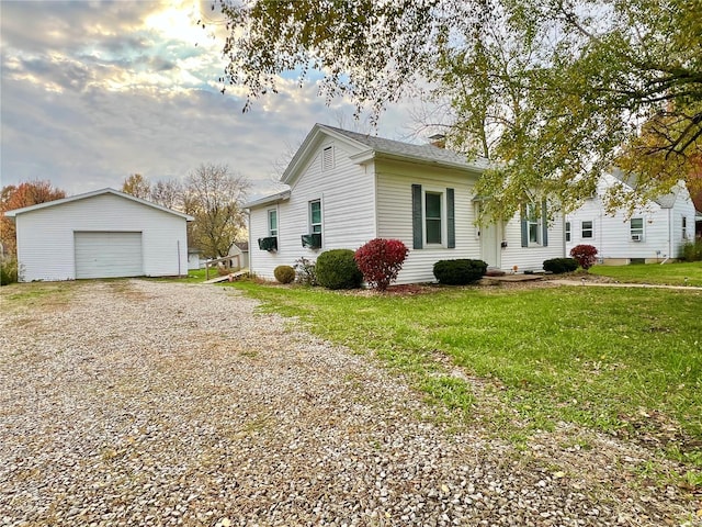 view of front of house with an outbuilding, a garage, and a front lawn