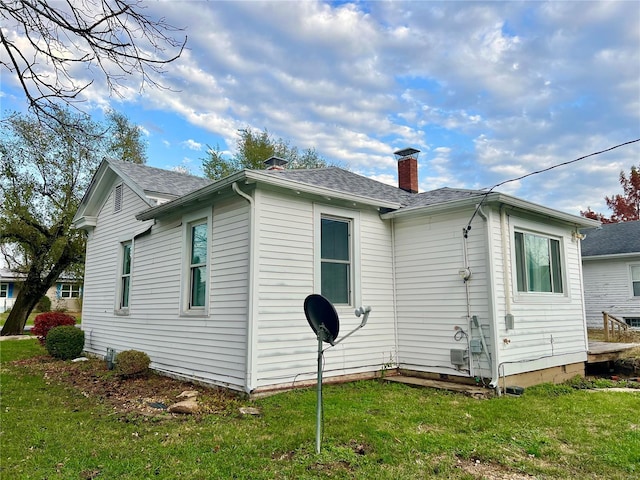 rear view of property with a yard