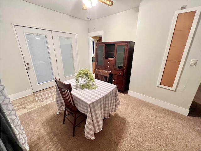 carpeted dining space featuring ceiling fan