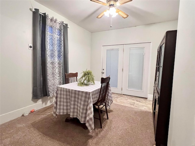 carpeted dining area featuring ceiling fan