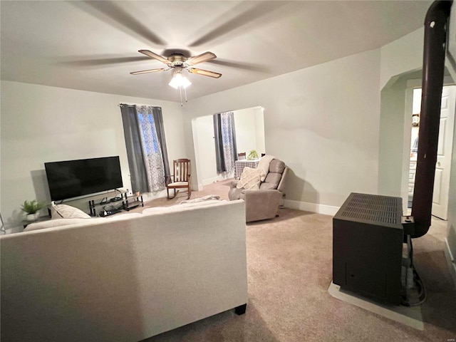 carpeted living room with ceiling fan