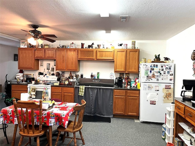 kitchen with a textured ceiling, ceiling fan, and white appliances