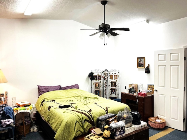 bedroom featuring carpet, ceiling fan, lofted ceiling, and a textured ceiling