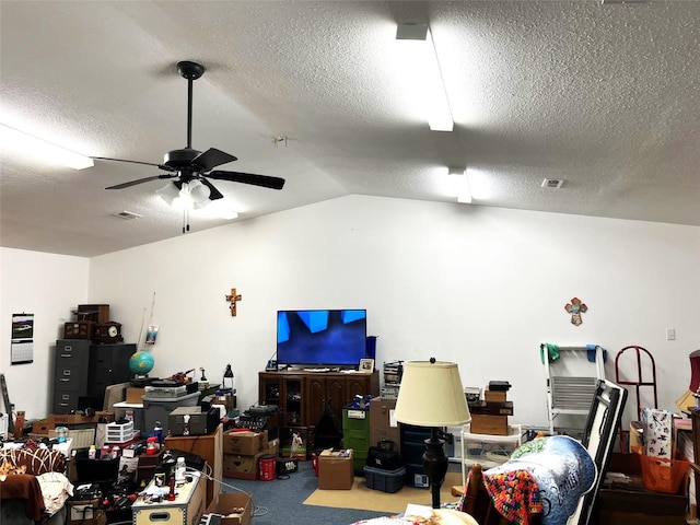 interior space featuring a textured ceiling, ceiling fan, carpet, and vaulted ceiling