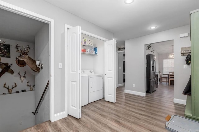 corridor featuring washer and clothes dryer and light hardwood / wood-style flooring