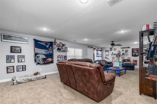 carpeted living room with ceiling fan and a textured ceiling