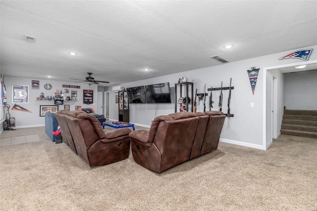 living room with light carpet, ceiling fan, and a textured ceiling