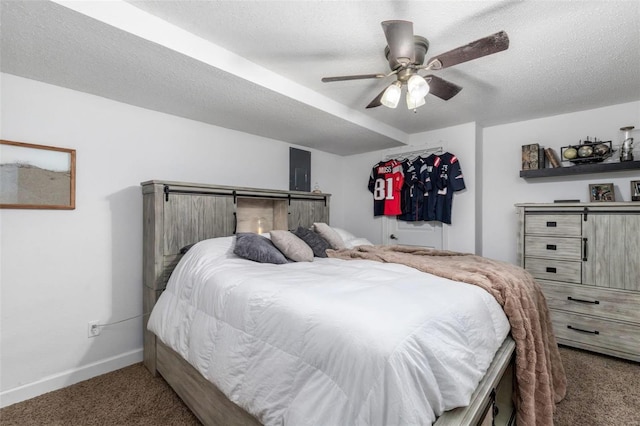 bedroom with ceiling fan, carpet floors, and a textured ceiling