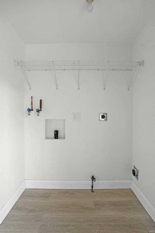 laundry area featuring electric dryer hookup and wood-type flooring