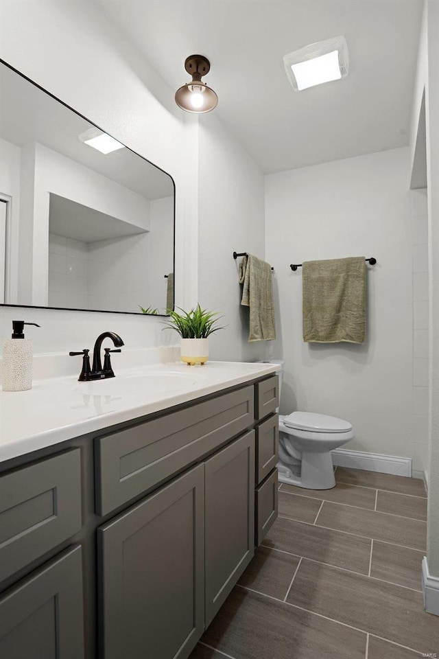 bathroom featuring vanity and toilet