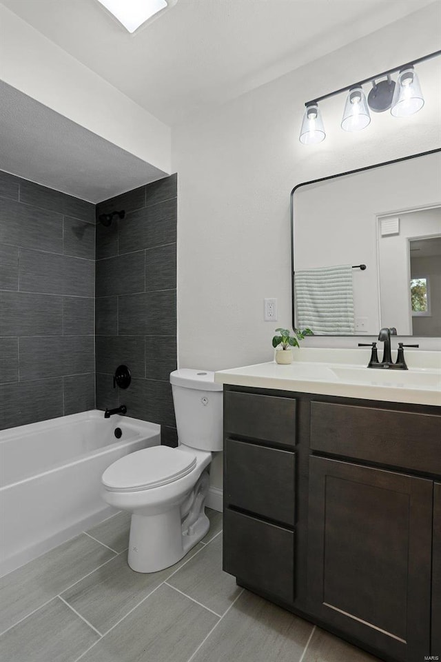 full bathroom featuring vanity, toilet, and tiled shower / bath