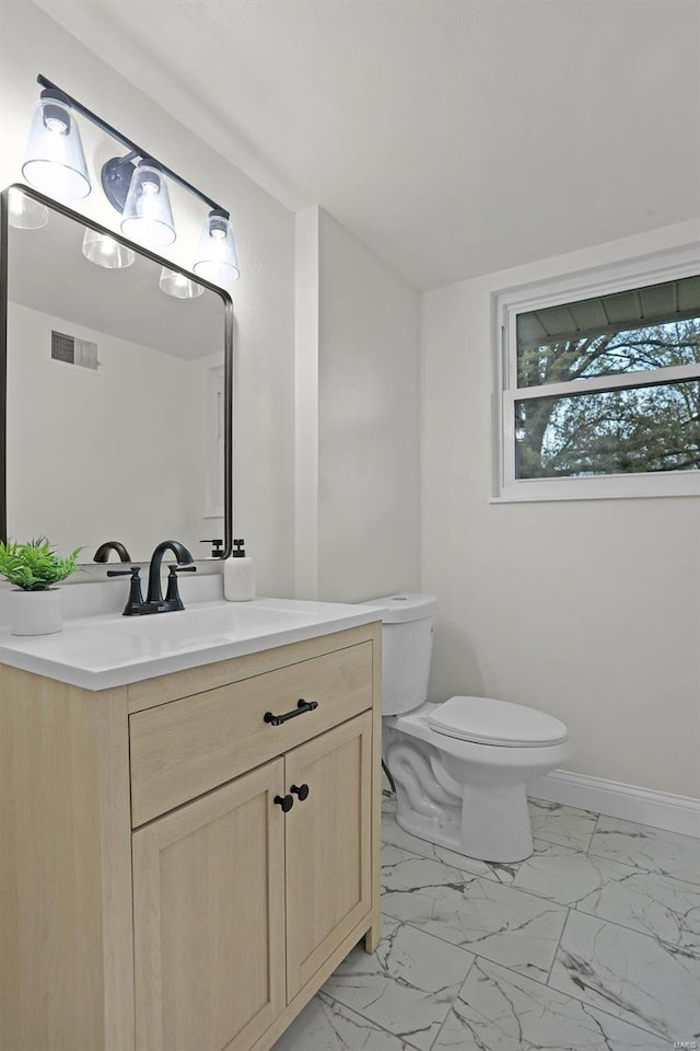 bathroom with vanity and toilet