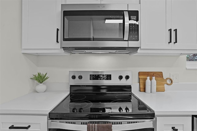 kitchen with white cabinets and appliances with stainless steel finishes