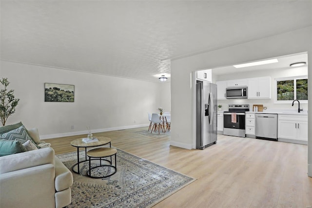 living room featuring light hardwood / wood-style flooring and sink