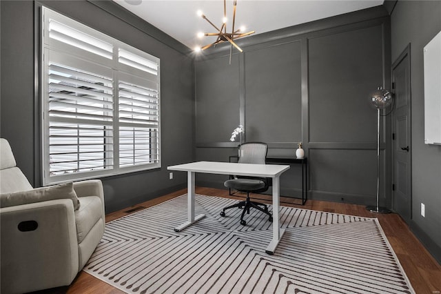 office space with crown molding, dark hardwood / wood-style floors, and an inviting chandelier